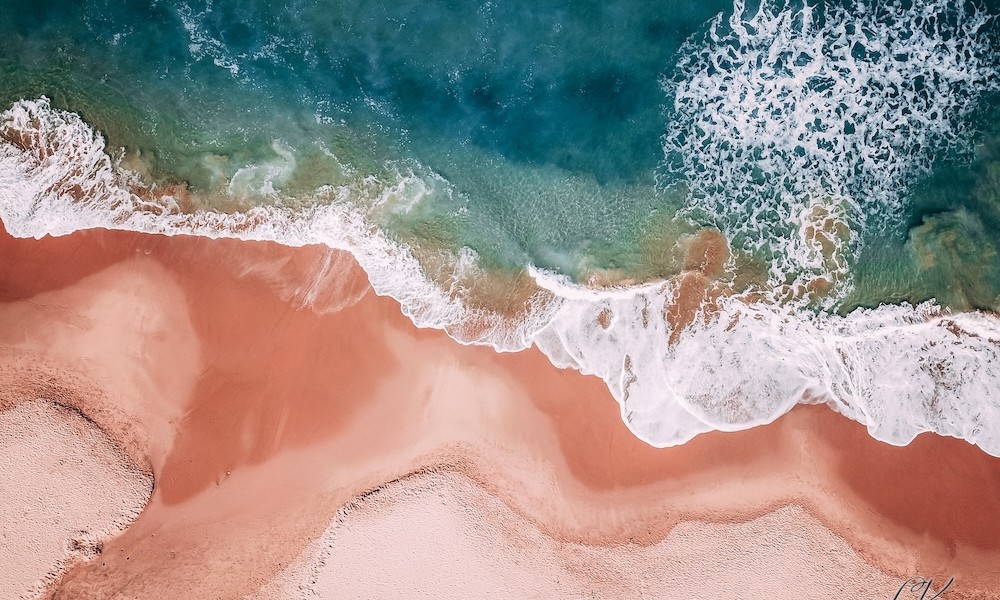 drone view of the beach and waves